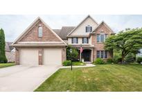 Charming two-story brick home featuring an attached two-car garage and well-manicured front lawn at 47 Torrey Pine Dr, Brownsburg, IN 46112