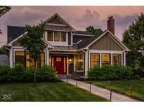 Charming two-story home with a red front door, well-manicured lawn, and inviting walkway at 5425 N Delaware St, Indianapolis, IN 46220