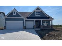 Charming home featuring a two-car garage and stylish exterior with a combination of brick and blue siding accents at 6367 Stone Side Dr, Plainfield, IN 46168