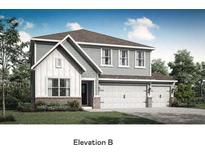 Charming two-story home with a 3-car garage, beautiful architectural details, and a well-manicured lawn at 7679 Barston Way, Avon, IN 46123