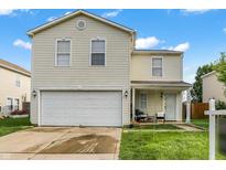 Charming two-story home featuring a two-car garage, a cozy front porch, and well-maintained landscaping at 7906 States Bend Ln, Indianapolis, IN 46239