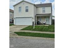 Charming two-story home with a well-maintained lawn and a two-car garage, creating a welcoming curb appeal at 7906 States Bend Ln, Indianapolis, IN 46239