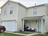 Charming home featuring a two-car garage and welcoming front porch at 7906 States Bend Ln, Indianapolis, IN 46239