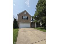Charming two-story brick home with a two-car garage and landscaped front yard at 10523 Dark Star Dr, Indianapolis, IN 46234