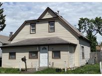 Charming two-story home with vinyl siding, a newer roof, and a 'For Sale' sign in the window at 1163 Groff Ave, Indianapolis, IN 46222