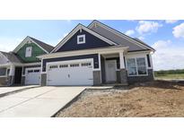 New construction home featuring a two-car garage, stone accents, and a modern, stylish design at 12532 Morning Ridge Way, Noblesville, IN 46060