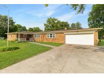 Charming single-story brick house with an attached two-car garage and a well-manicured front yard at 227 Vestal Rd, Plainfield, IN 46168