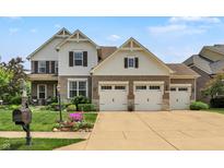 Charming two-story home boasts a three-car garage, landscaped yard, and classic brick and siding exterior at 2715 Benmore Ct, Zionsville, IN 46077