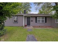Charming single-story home with gray siding, a black front door, and a well-maintained front yard at 3509 N Wittfield St, Indianapolis, IN 46235