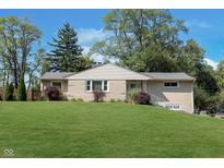Charming brick ranch home with a lush green lawn and mature trees, offering a picturesque curb appeal at 3740 Cheviot Pl, Indianapolis, IN 46205