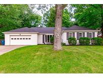 Charming single-story home with a well-manicured lawn and an attached two-car garage at 535 Radburn Dr, Indianapolis, IN 46214