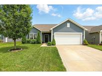 Charming single-story home featuring a well-manicured lawn, mature tree, and a two-car attached garage at 6315 Emerald Field Way, Indianapolis, IN 46221