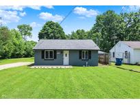 Charming single-story home showcasing a well-maintained lawn and neutral exterior paint at 6949 Crittenden Ave, Indianapolis, IN 46220