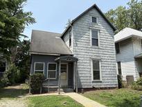 A charming, two-story home with a covered entryway and a well-manicured front lawn at 807 N Elm St, Muncie, IN 47305