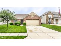 Beautiful brick home with a two-car garage, healthy green lawn, and manicured landscaping for great curb appeal at 8116 Harshaw Dr, Indianapolis, IN 46239