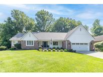 Charming single-story home with a well-manicured lawn, brick accents, and an attached two-car garage at 8429 Catamaran Dr, Indianapolis, IN 46236