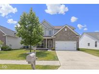 Charming two-story home with a brick and siding exterior, manicured lawn, and inviting front porch, creating curb appeal at 8720 N Deer Crossing Blvd, McCordsville, IN 46055