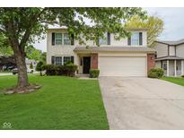 Charming two-story home with a well-manicured lawn, two-car garage, and traditional siding at 10420 Day Star Dr, Indianapolis, IN 46234