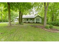 Charming one-story home with a welcoming front porch and lush, mature trees in a peaceful, wooded setting at 10808 Greenbriar Dr, Fishers, IN 46037