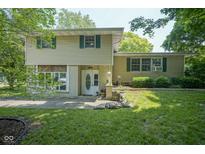 Charming two-story home with green shutters, landscaped front yard and a lovely front entrance at 1524 Northcrest Dr, Anderson, IN 46012