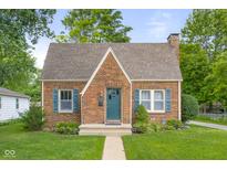 Charming brick home featuring a well-manicured lawn, complemented by vibrant landscaping and inviting curb appeal at 1944 Union St, Columbus, IN 47201