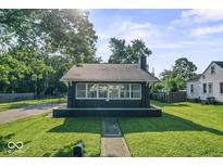 Charming home featuring a well-maintained lawn, covered front porch, and classic architectural details at 2719 Denison St, Indianapolis, IN 46241