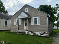 Charming single Gathering home featuring a gable roof, siding, and a small front porch at 4715 Normal Ave, Indianapolis, IN 46226