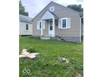 Charming home featuring light tan siding and a cozy front entrance at 4715 Normal Ave, Indianapolis, IN 46226
