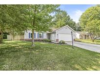 Charming single-story home featuring blue shutters, a well-manicured lawn, and an attached two-car garage at 5289 Pine Hill Dr, Noblesville, IN 46062