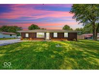 Charming brick home with a well-manicured lawn and lovely landscaping at 608 W 600 N, Fortville, IN 46040