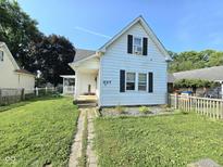 Charming white home with a well-manicured lawn and inviting front porch at 627 Plum St, Noblesville, IN 46060