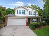 Charming two-story home with a brick facade, vinyl siding and a two-car garage at 6412 Cradle River Dr, Indianapolis, IN 46221