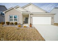 Charming single-Gathering home featuring a two-car garage and well-maintained front yard at 6608 W Shoreline Ct, Greenfield, IN 46140