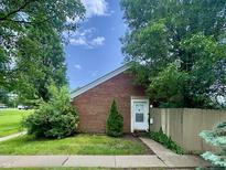 Charming single-Gathering home with brick facade and well-maintained front yard with mature trees at 7392 S Meridian St, Indianapolis, IN 46217