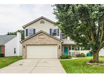 Charming two-story home featuring a brick-accented facade, attached garage, and inviting covered porch at 1112 Halifax Ct, Indianapolis, IN 46231
