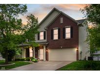 Charming two-story home with brick and siding exterior and a well-maintained front lawn at 11138 Bear Hollow Dr, Indianapolis, IN 46229