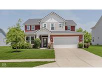 Charming two-story home with landscaped yard and a welcoming entrance, plus a two car garage at 11840 Crossbill Ct, Noblesville, IN 46060