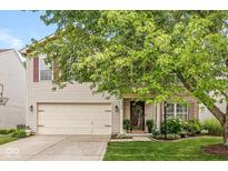 Charming two-story home with a well-manicured lawn, attached garage, and inviting front entrance at 12259 Sweet Creek Trl, Fishers, IN 46037