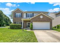 Charming two-story home with a brick and vinyl exterior, a well-manicured lawn, and an attached two-car garage at 12322 Cool Winds W Way, Fishers, IN 46037