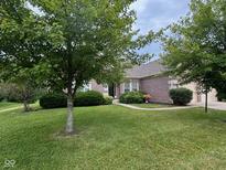 Charming brick home with mature trees and lush landscaping at 13744 Fieldshire Ter, Carmel, IN 46074