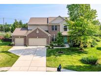 Charming two-story home with a well-manicured lawn, attached three-car garage, and inviting curb appeal at 14109 Secretariat Ct, Carmel, IN 46074