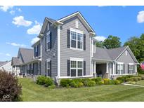 Beautifully landscaped home with gray siding and black shutters, offering an inviting curb appeal at 14234 Community Dr, Carmel, IN 46033