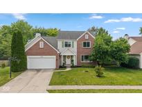 Charming two-story brick and siding home with a well-manicured lawn and inviting front entrance at 14492 Cotswold Ln, Carmel, IN 46033