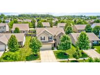 Charming two-story home featuring manicured lawn, two-car garage and mature trees in a beautiful residential neighborhood at 15178 Silver Charm Dr, Noblesville, IN 46060