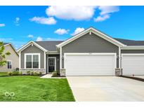 Charming gray home with a well-manicured lawn and a two-car garage, all under a beautiful blue sky at 2021 Frost Line Ln, Greenfield, IN 93927