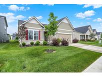 Charming single-story home with a well-manicured lawn and beautiful landscaping at 2612 Ruffian Dr, Westfield, IN 46074