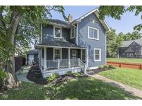 Charming two-story home with a welcoming front porch and nicely landscaped front yard at 2860 Winthrop Ave, Indianapolis, IN 46205