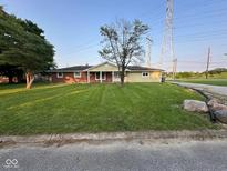 Charming single-story home with a well-manicured lawn and a mix of brick and siding at 2951 S Elizabeth St, Indianapolis, IN 46203