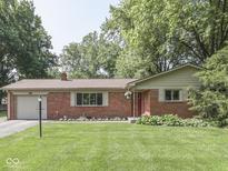 Charming single-story brick home with a well-manicured lawn and inviting curb appeal at 343 E Waterbury Rd, Indianapolis, IN 46227