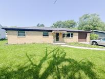 Charming brick ranch-style home featuring a well-maintained lawn and mature trees at 3613 N Locust St, Muncie, IN 47304